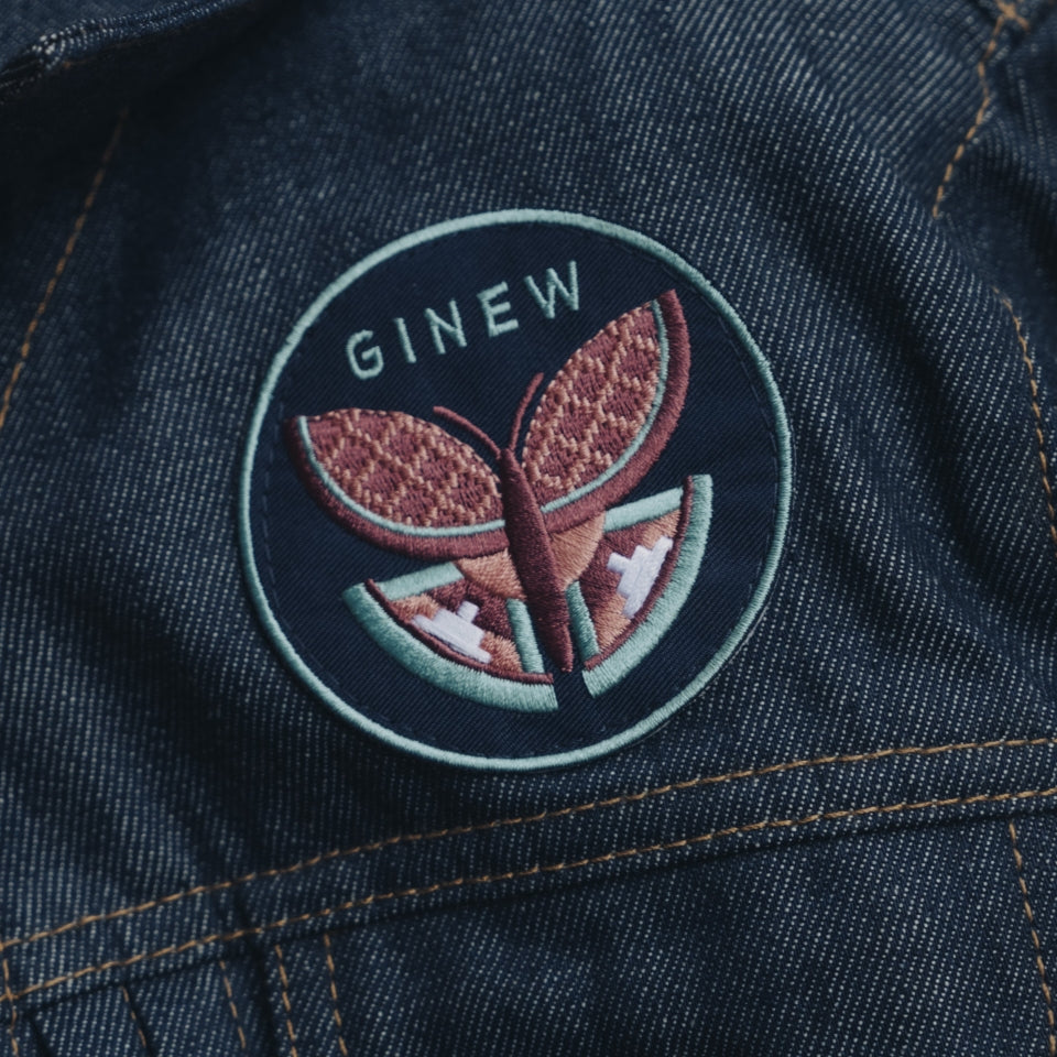 Embroidered butterfly patch on denim jacket